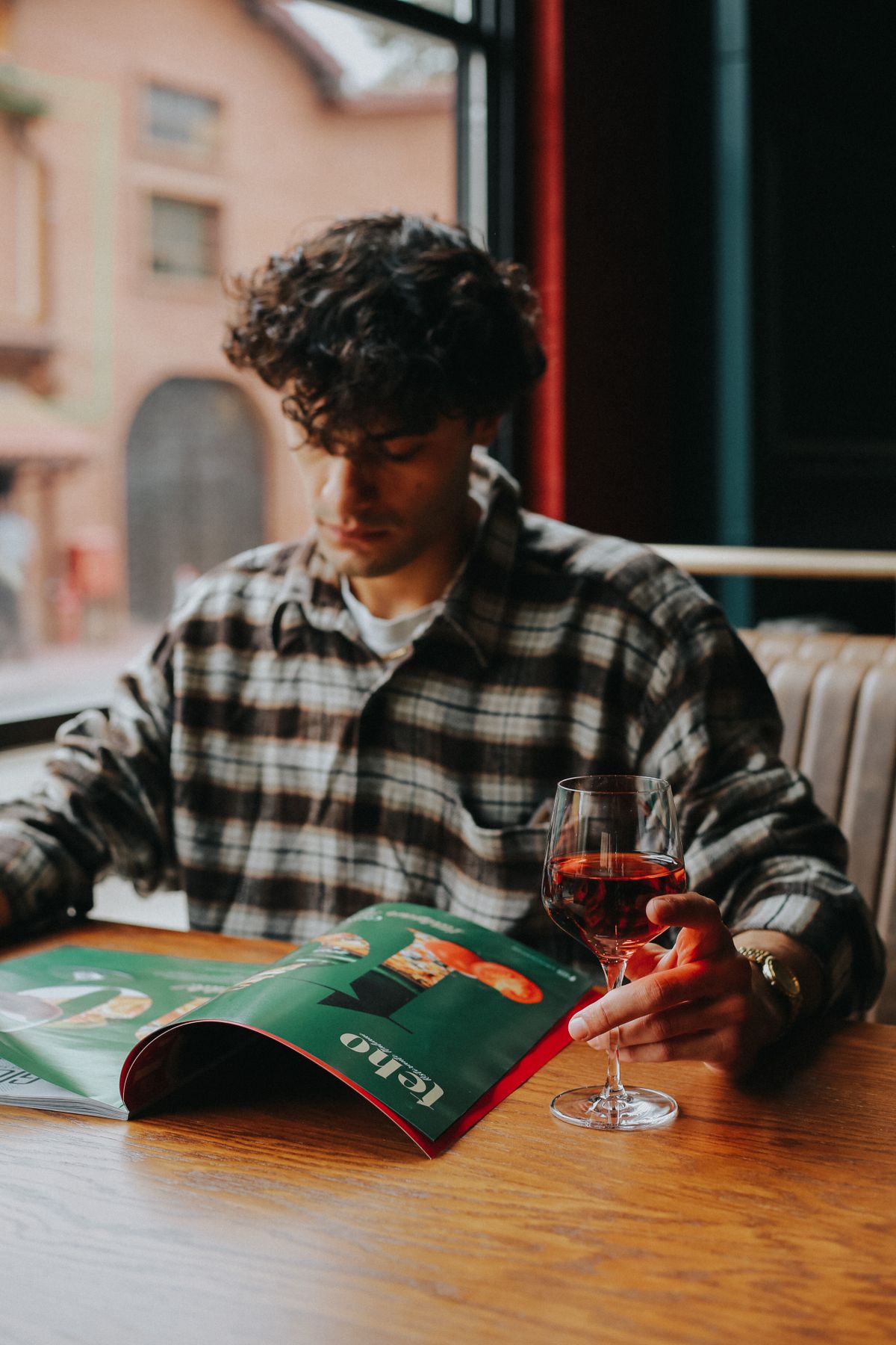A checked overshirt worn at a café table after work.