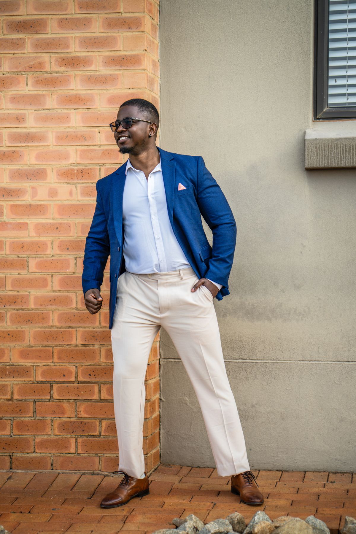 A blue blazer paired with pale chinos and brown shoes.
