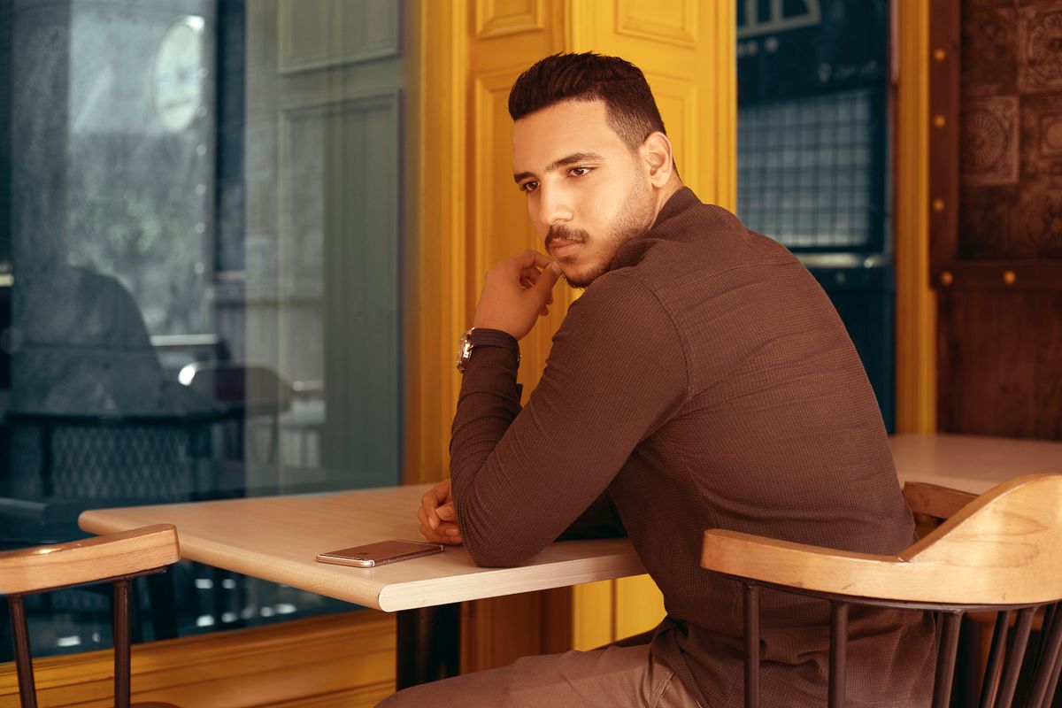 A brown casual shirt worn at a cafe table.