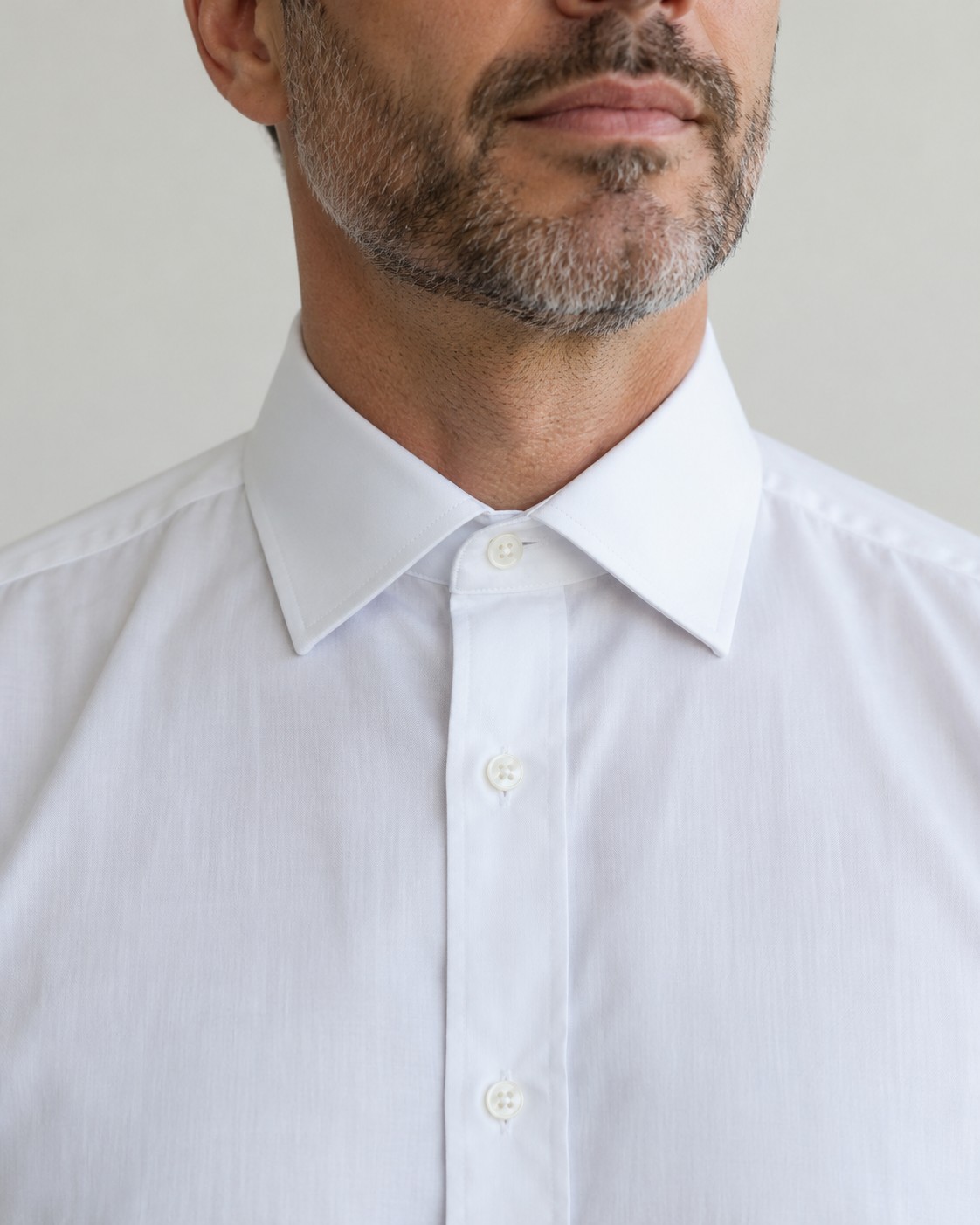 A white shirt collar fastened comfortably without a tie.