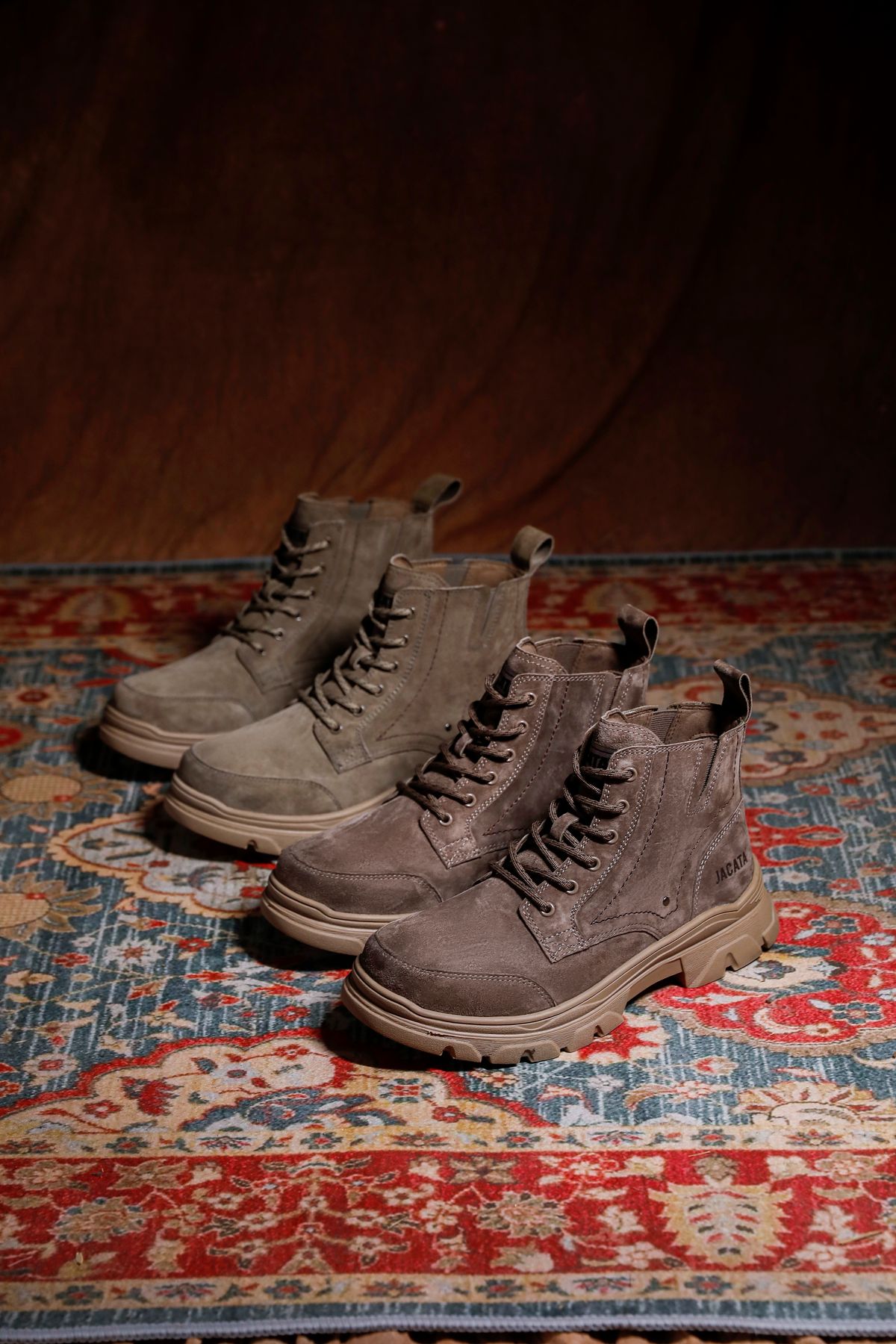 Two pairs of brown lace-up boots with substantial soles.